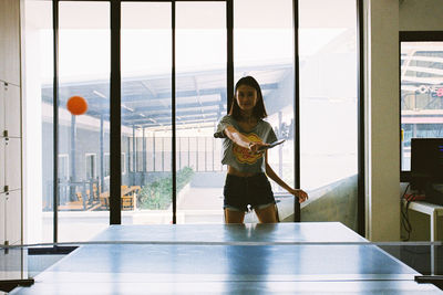 Woman standing by window