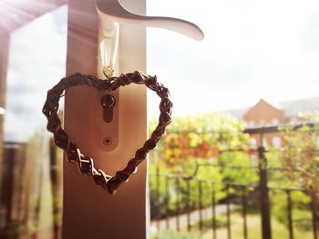 Close-up of padlocks hanging on metal against sky