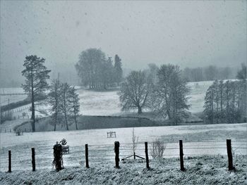 Scenic view of snowy field against sky during winter