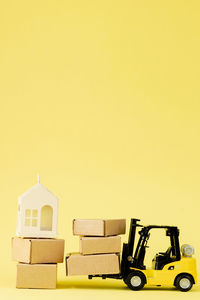 Close-up of toy blocks against yellow background