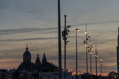 Illuminated buildings against sky during sunset