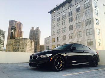 Car in city against sky