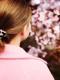 Rear view of woman with pink flower