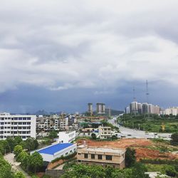 Cityscape against cloudy sky