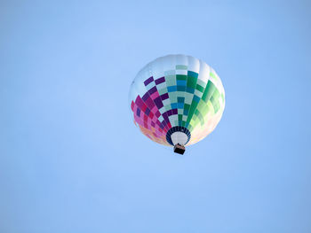 Low angle view of hot air balloon against blue sky