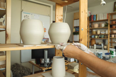 Woman holding pottery vase she made