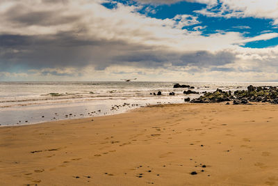 Scenic view of beach against sky