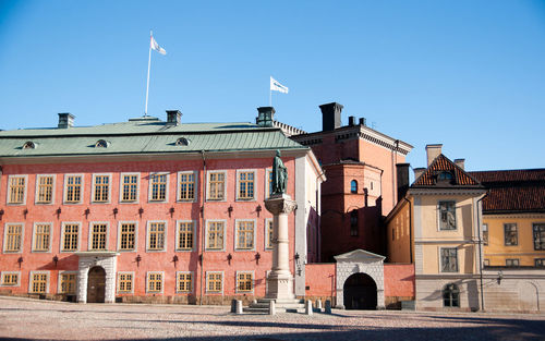 Buildings against clear blue sky