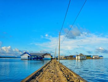 Sailboat on sea against blue sky