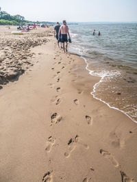 People on beach against sky