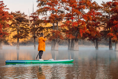 Rear view of man standing in lake