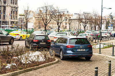 Cars on street against buildings in city