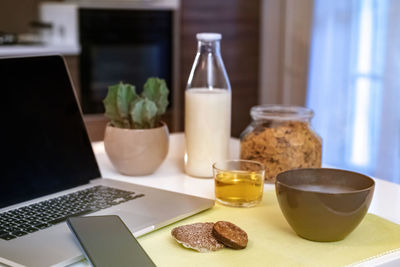 Table set for breakfast. natural meal and technology devices.  home working, remote work concept.