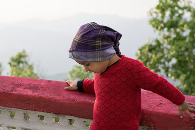 Rear view of girl wearing red hat