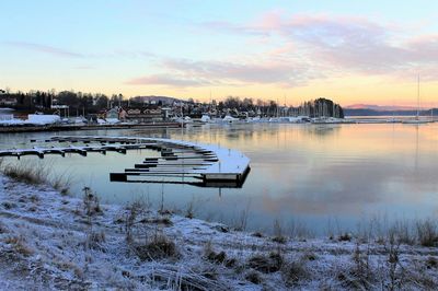 Scenic view of frozen lake against sky during sunset