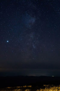 Scenic view of silhouette landscape against star field at night