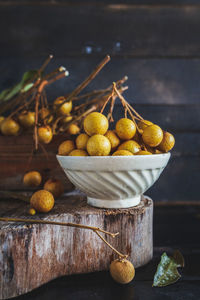 Longans in bowl and box on wood