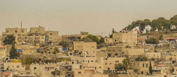 Buildings in city against clear sky