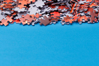 Close-up of jigsaw piece on blue background