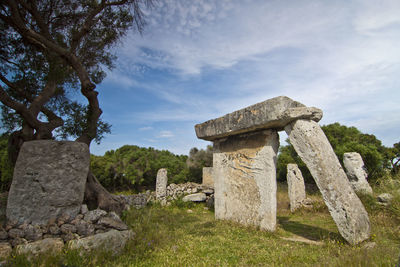 Stone structure against cloudy sky