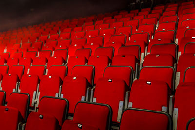 Low angle view of empty red chairs in movie theater