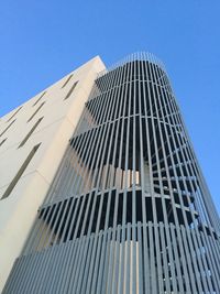 Low angle view of modern building against clear blue sky