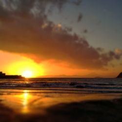 Scenic view of sea against orange sky