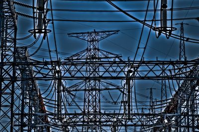 Low angle view of electricity pylon against sky