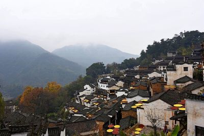 High angle view of houses in town against clear sky