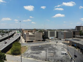 High angle view of street amidst buildings against sky