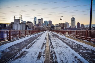 View of railroad tracks in city during winter