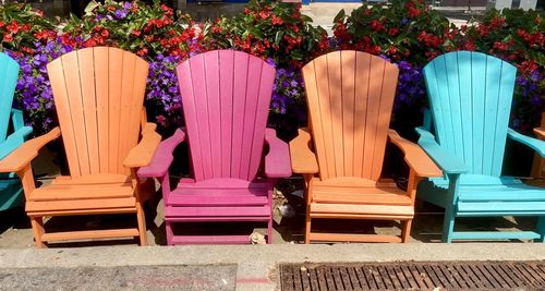 Empty chairs against plants