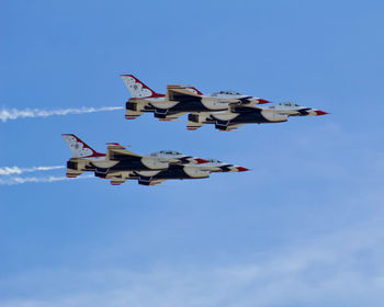 Low angle view of airshow against clear sky