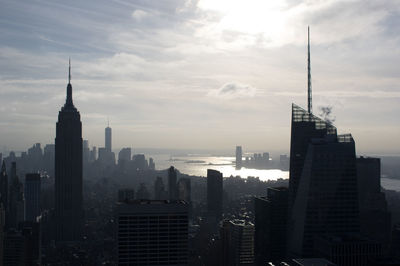 Skyscrapers against cloudy sky