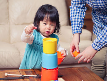 Girl playing with colorful toys at home