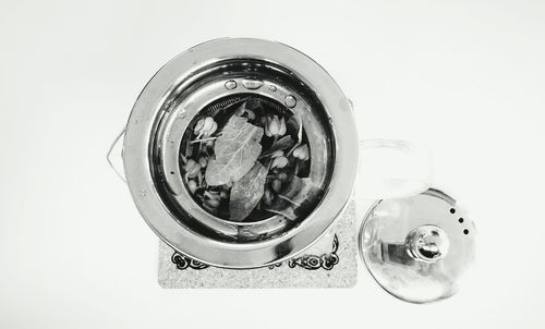 High angle view of wine glass on table against white background