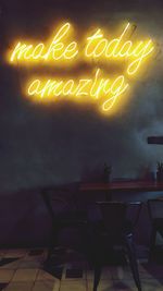 Information sign on illuminated restaurant at night