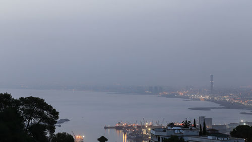 High angle view of buildings by sea against sky