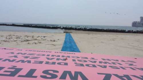 Text written on pier at beach