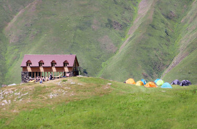 Panoramic view of people on field against mountain