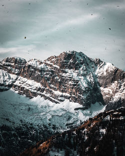 Scenic view of snowcapped mountains by sea against sky