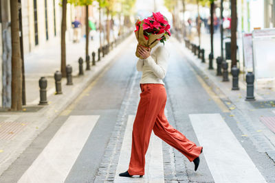 Full length of woman walking on street