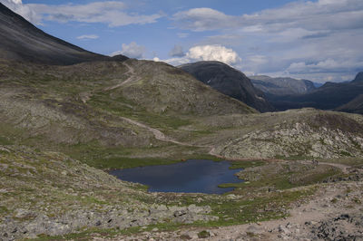 Scenic view of lake and mountains against sky