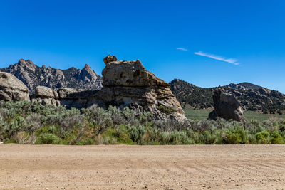 Scenic view of rocky mountains against blue sky