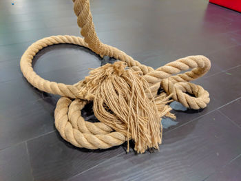 Close-up of rope tied on wooden table