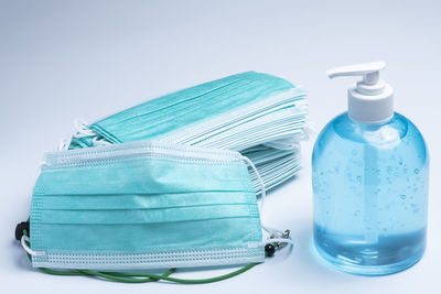 Close-up of blue bottle against white background