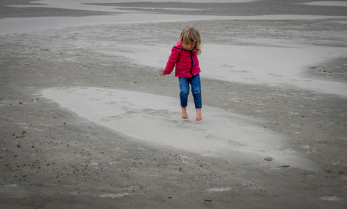 Full length of girl jumping at beach