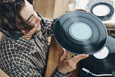 Side view of man holding camera