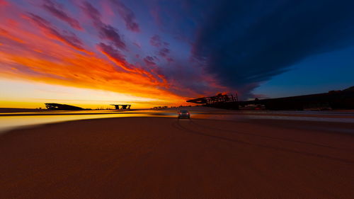 Road against dramatic sky during sunset