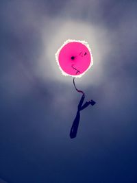 Low angle view of pink balloon flying against sky